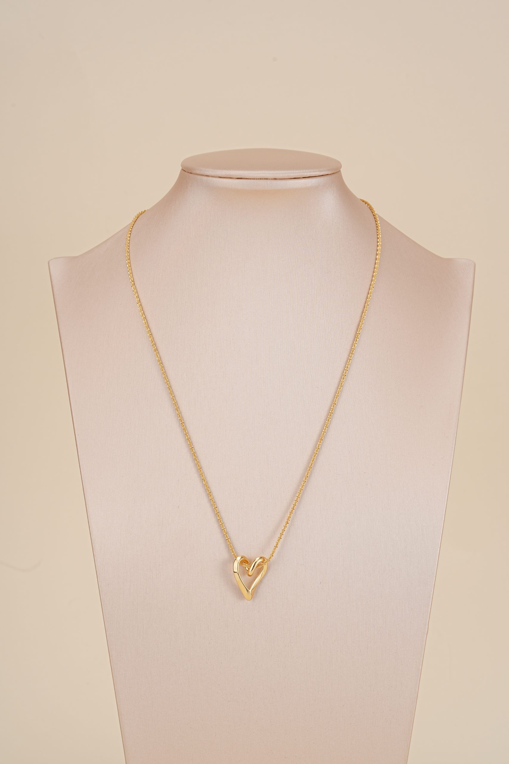 Wood-bead and pearl necklace displayed on a jewelry bust