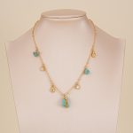 Turquoise charm bead chain necklace displayed on jewelry bust