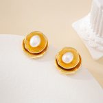 Close-up of textured gold-toned petals surrounding freshwater pearls