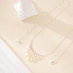 Silver-toned chain and clasp beside the necklace's nine pearl drops