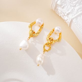 Close-up of round pearl studs and irregular pearl drops
