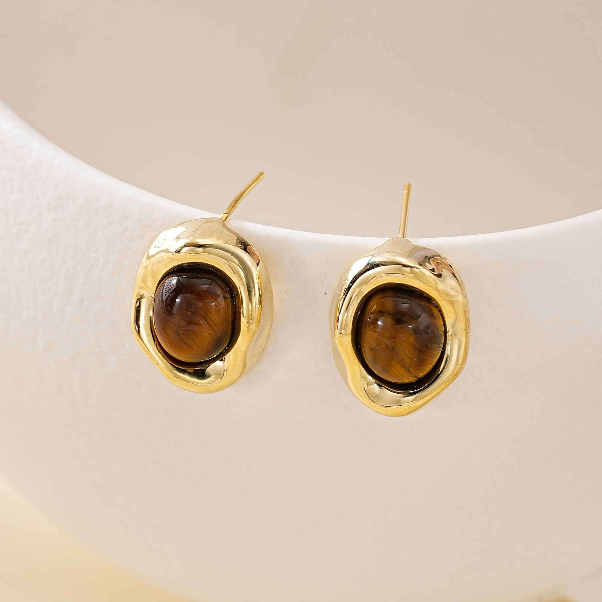 Front view of tiger eye studs showing warm brown stone patterns