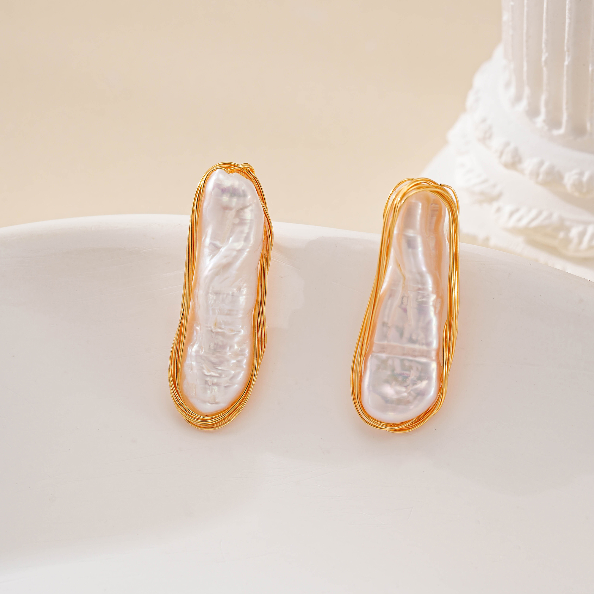 Front view of matching long pearl outline stud earrings