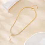 Gold-plated copper pearl drop necklace laid out with its extender chain