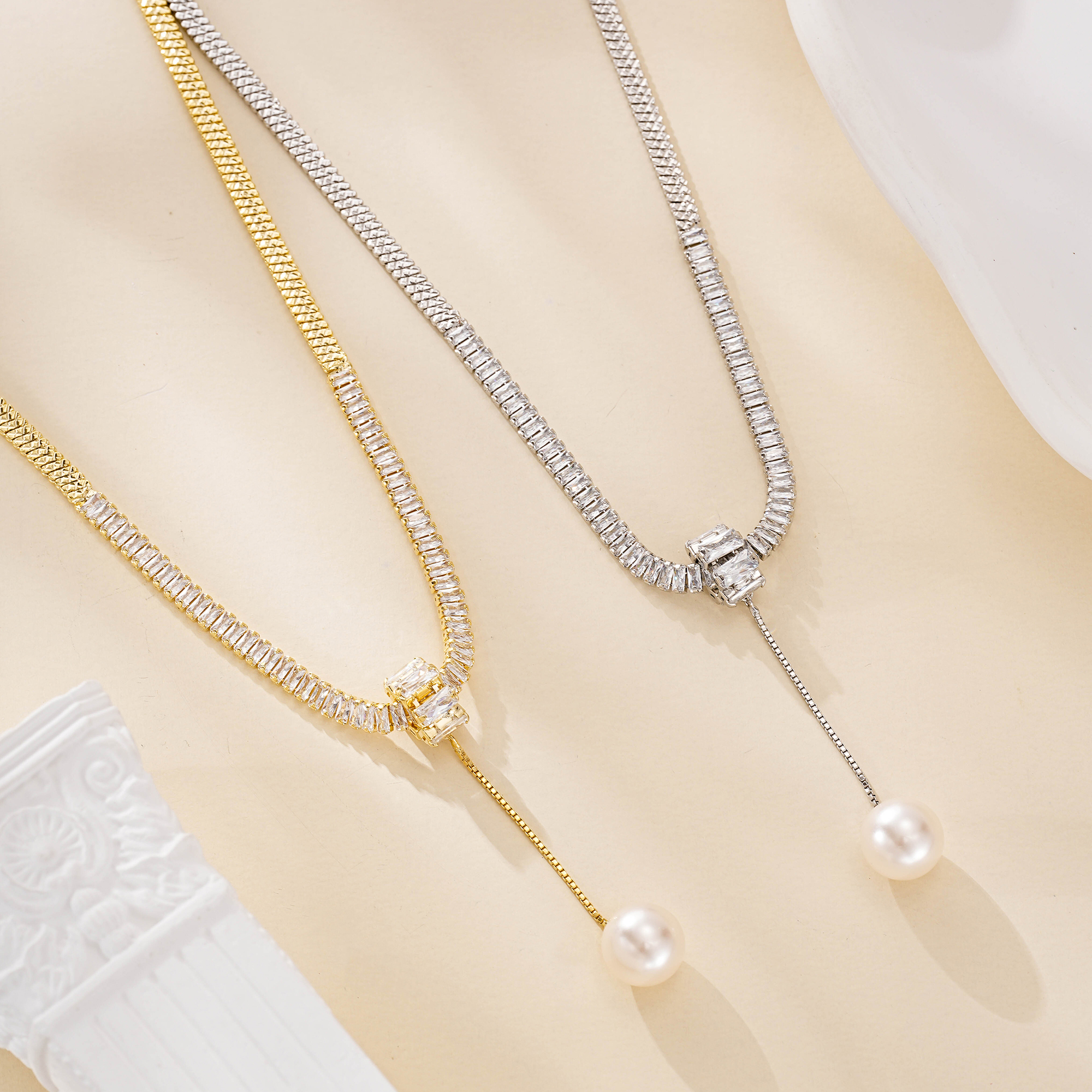 Gold and silver pearl drop snake chain necklace options shown together