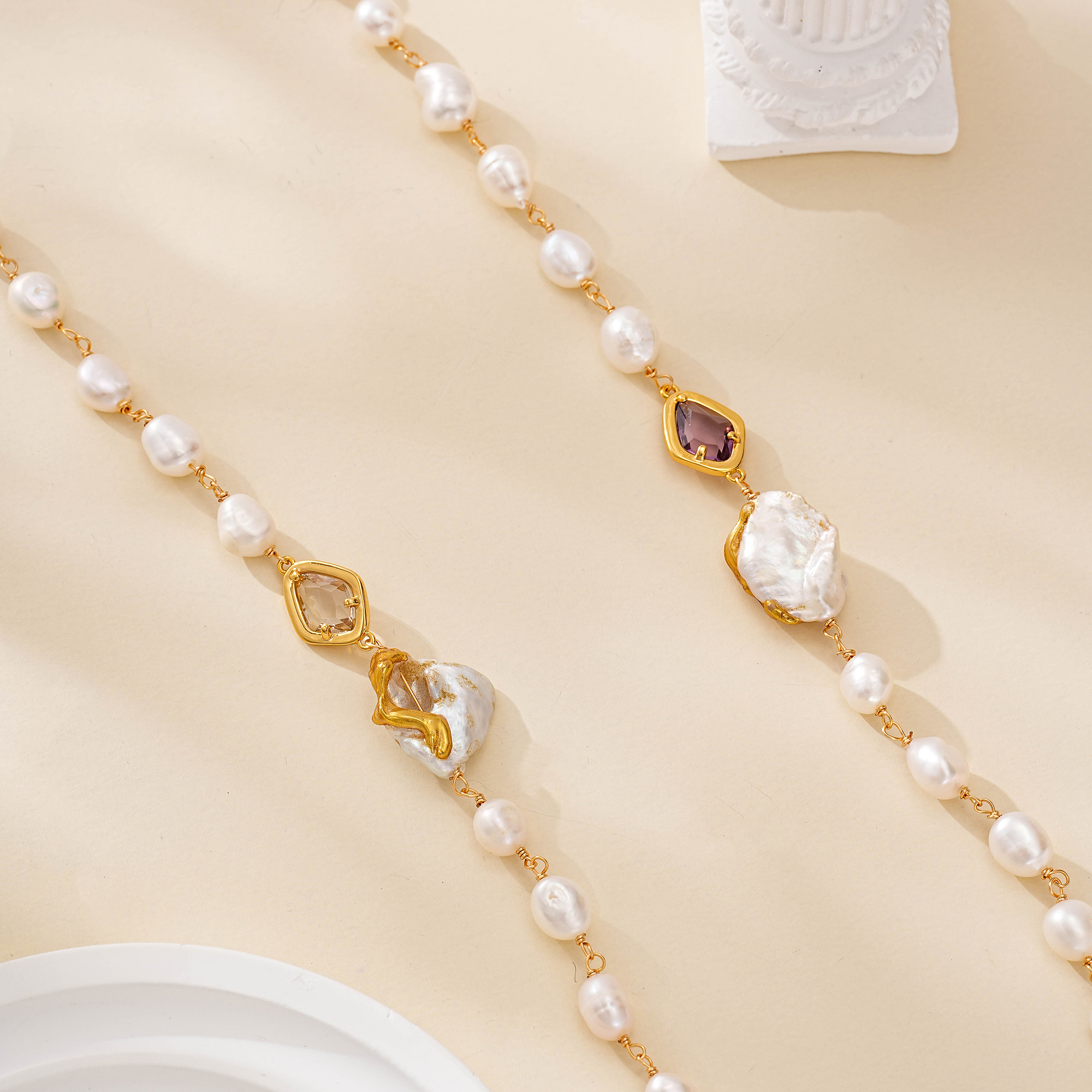 Close-up of freshwater pearls with violet, clear and gold-toned accents