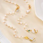 Long freshwater pearl necklace arranged in loose loops with colorful gold-framed accents