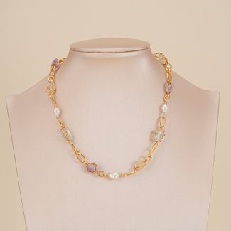 Colorful gemstone and pearl link necklace displayed on a neutral bust