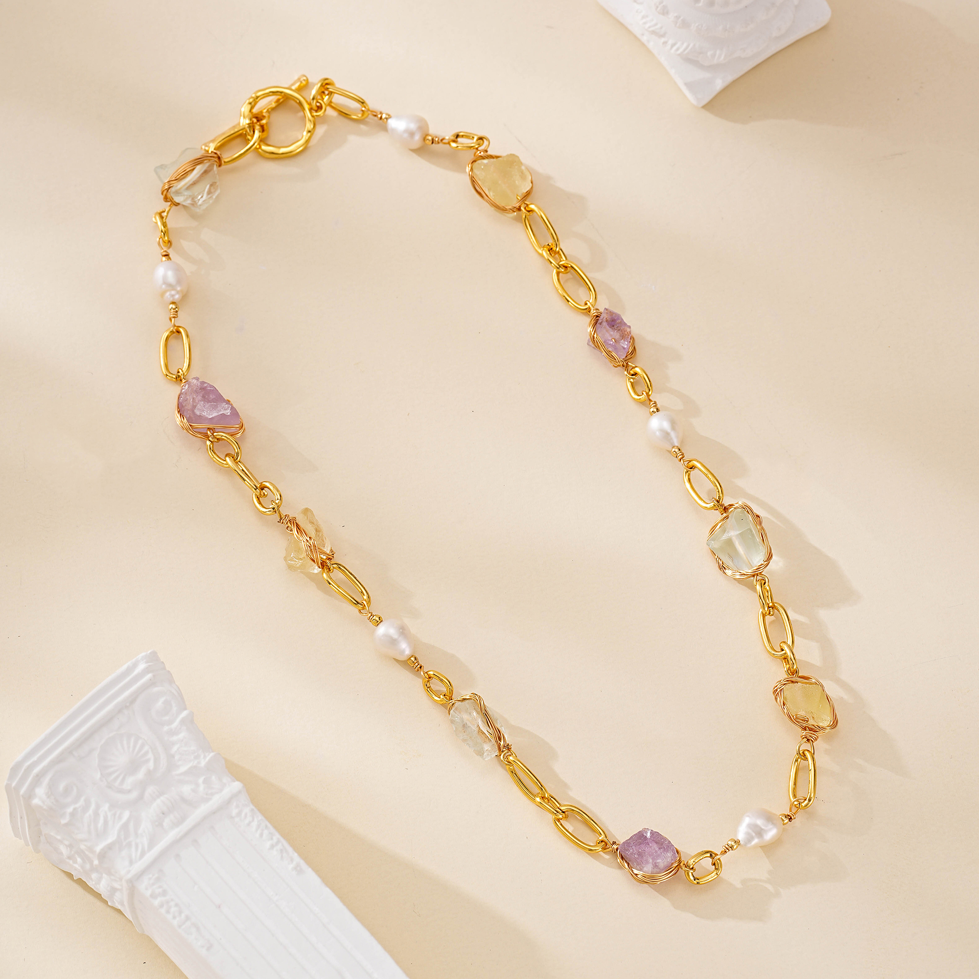 Gold-toned oval link necklace with colorful gemstones and freshwater pearls
