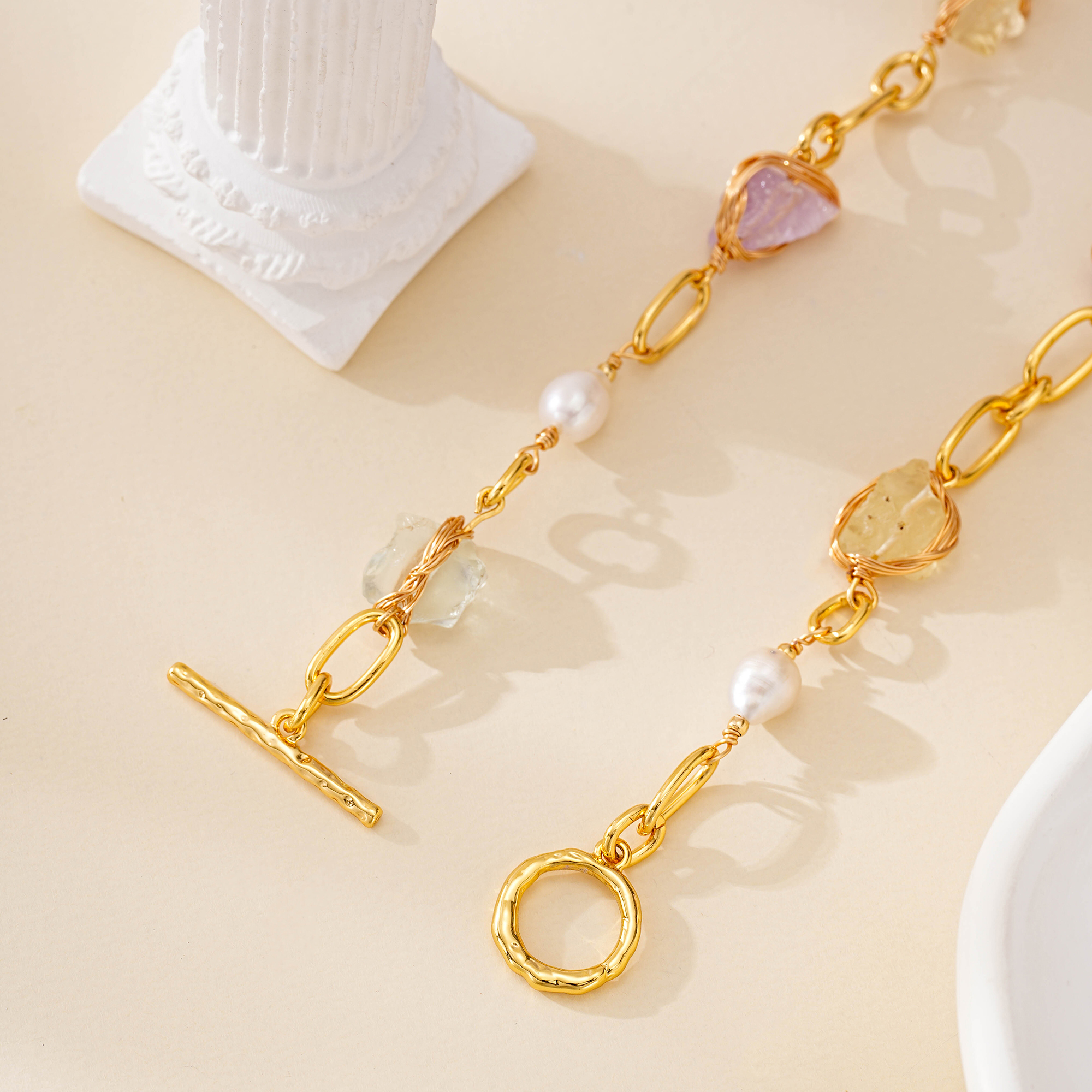 Gold-toned toggle clasp and mixed gemstone details of pearl necklace
