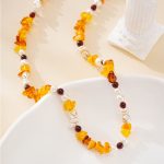 Amber-toned gemstone chip and baroque pearl necklace with dark round beads