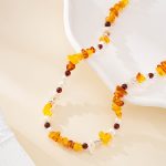 Detail of warm gemstone chips, dark beads and irregular white pearls