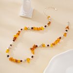 Full view of warm orange gemstone and pearl beaded necklace