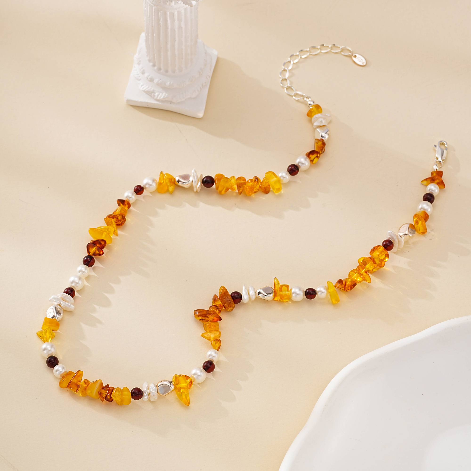 Full view of warm orange gemstone and pearl beaded necklace