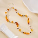 Necklace arranged in a loose loop showing alternating gemstones and pearls