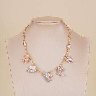 Blush baroque pearl fringe necklace displayed on a neutral bust
