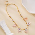 Gold-toned chain necklace with five blush baroque pearl drops