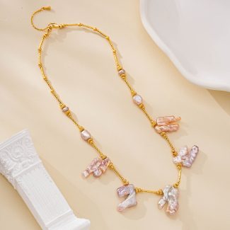Gold-toned chain necklace with five blush baroque pearl drops