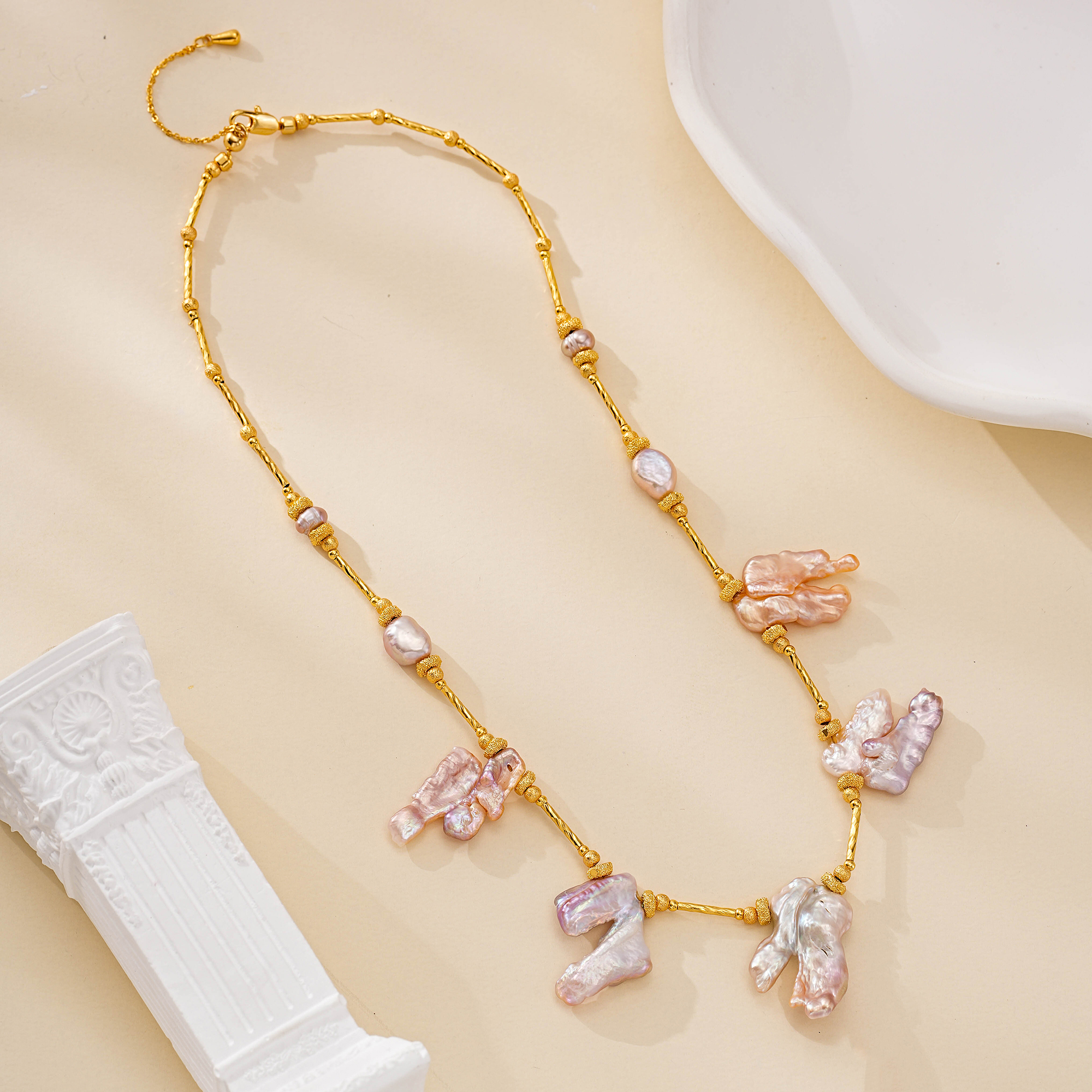 Gold-toned chain necklace with five blush baroque pearl drops