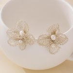 Openwork silver-toned wire flower earrings with two white freshwater pearls on each earring