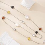 Close-up of alternating pearl and resin stations on necklace