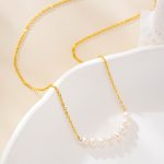 Close-up of the clustered-pearl necklace on a white dish