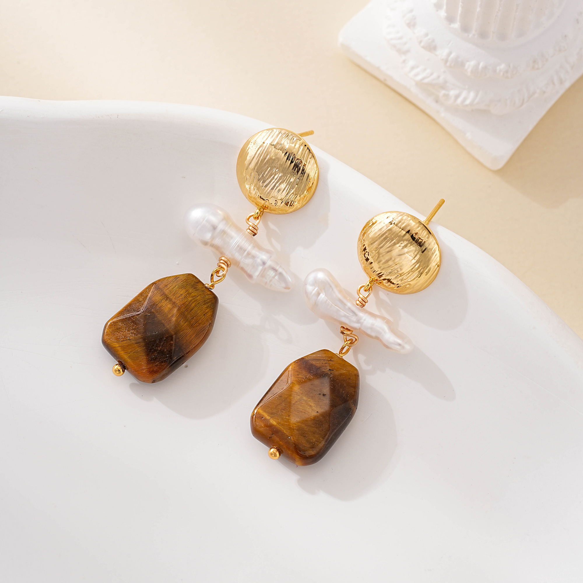 Close-up of wood and pearl geometric drop earrings