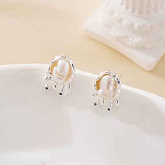 Molten silver-tone setting framing an irregular baroque pearl stud