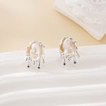 Sculptural silver-tone baroque pearl stud earrings shown as a pair