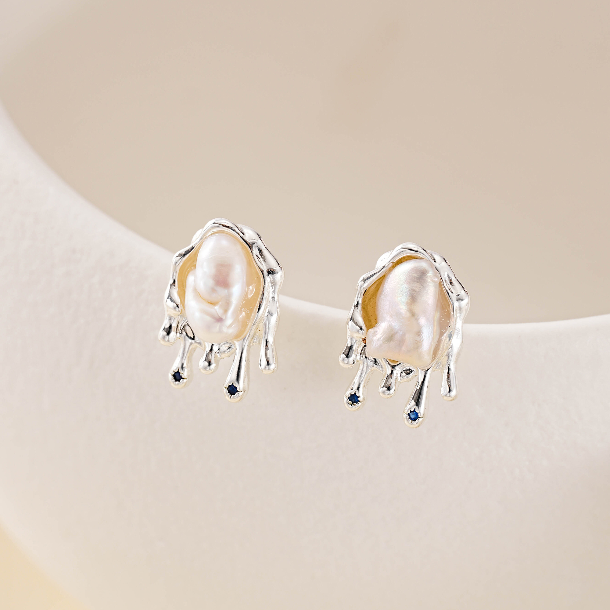 Baroque pearl studs with softly rippled silver-tone metalwork