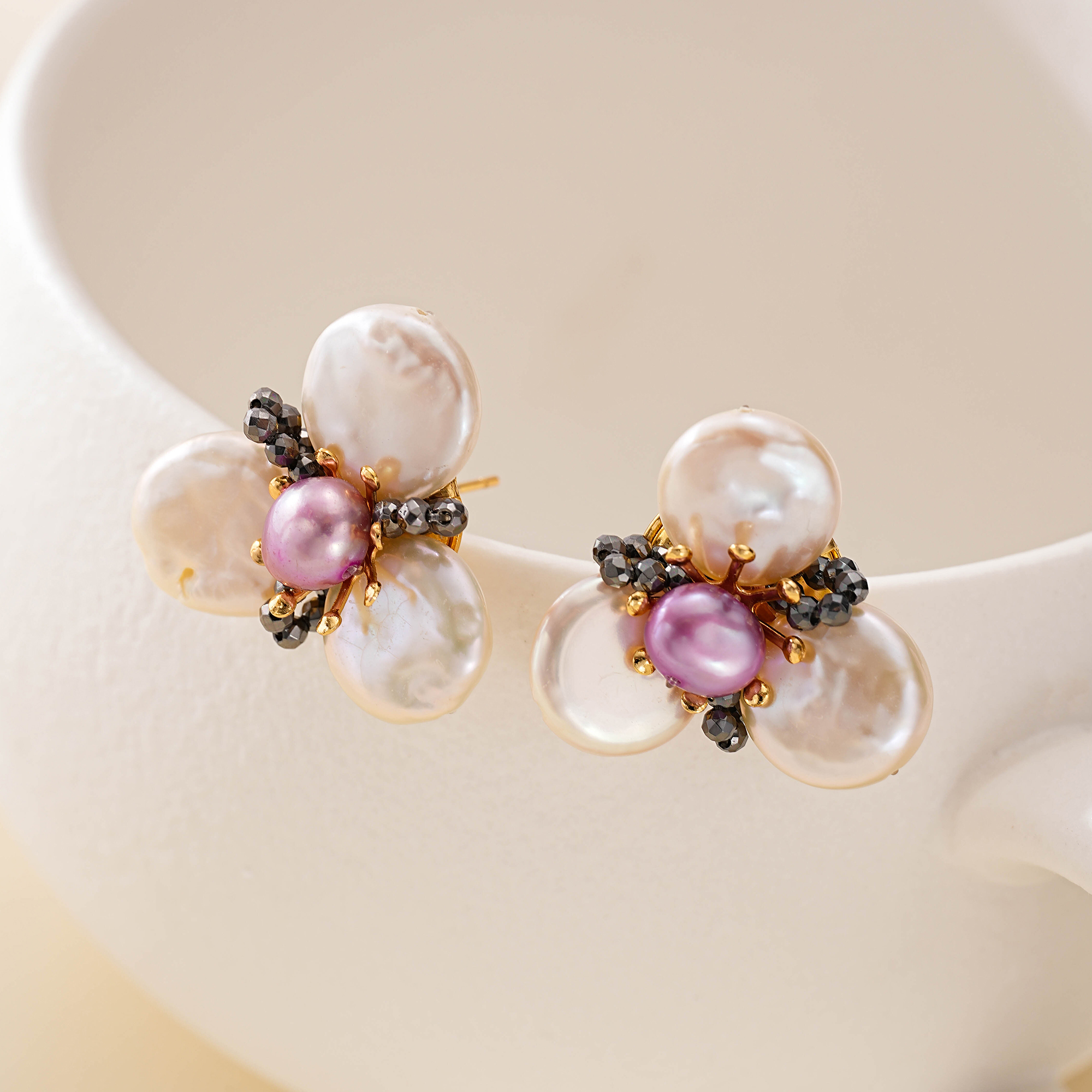 Petal-shaped baroque pearls in a gold-toned flower setting
