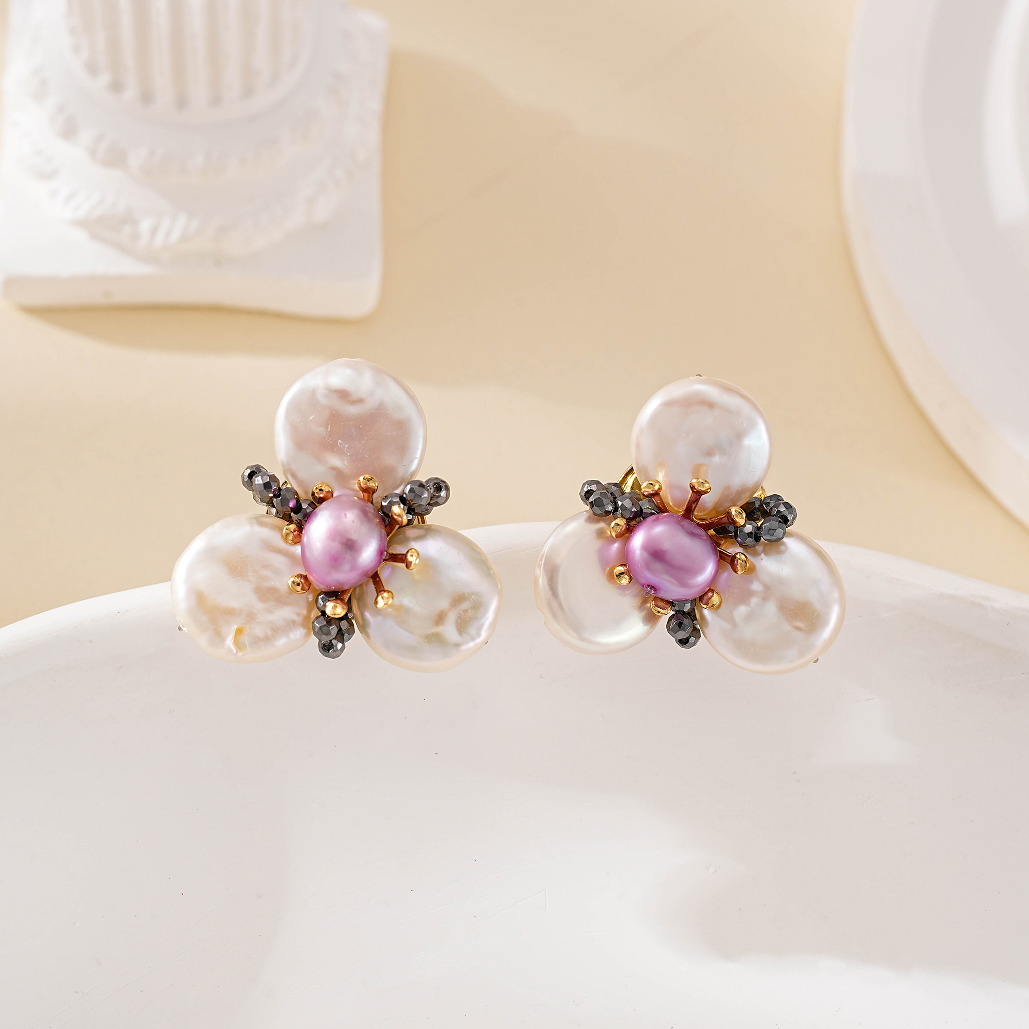 Close view of purple pearls and black spinel on floral studs