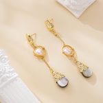 Asymmetrical pearl drop earrings with dark shell teardrops
