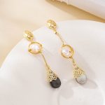 Uneven gold-tone chains and pearls on asymmetric drop earrings
