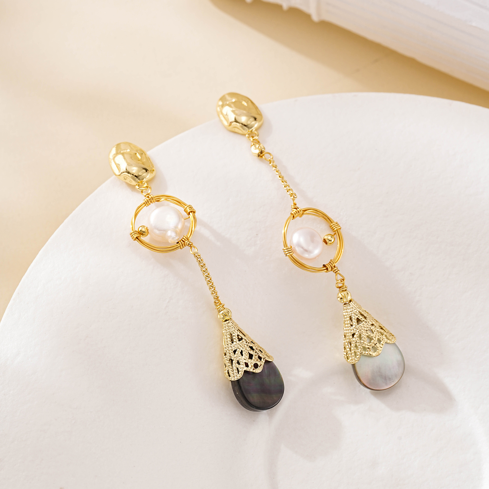 Uneven gold-tone chains and pearls on asymmetric drop earrings