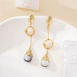 Pair of mixed-length pearl and black shell dangle earrings