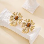 Mixed gold- and silver-tone rays around tiger's eye stones