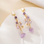 White carved flowers amid amethyst and freshwater pearl tassels
