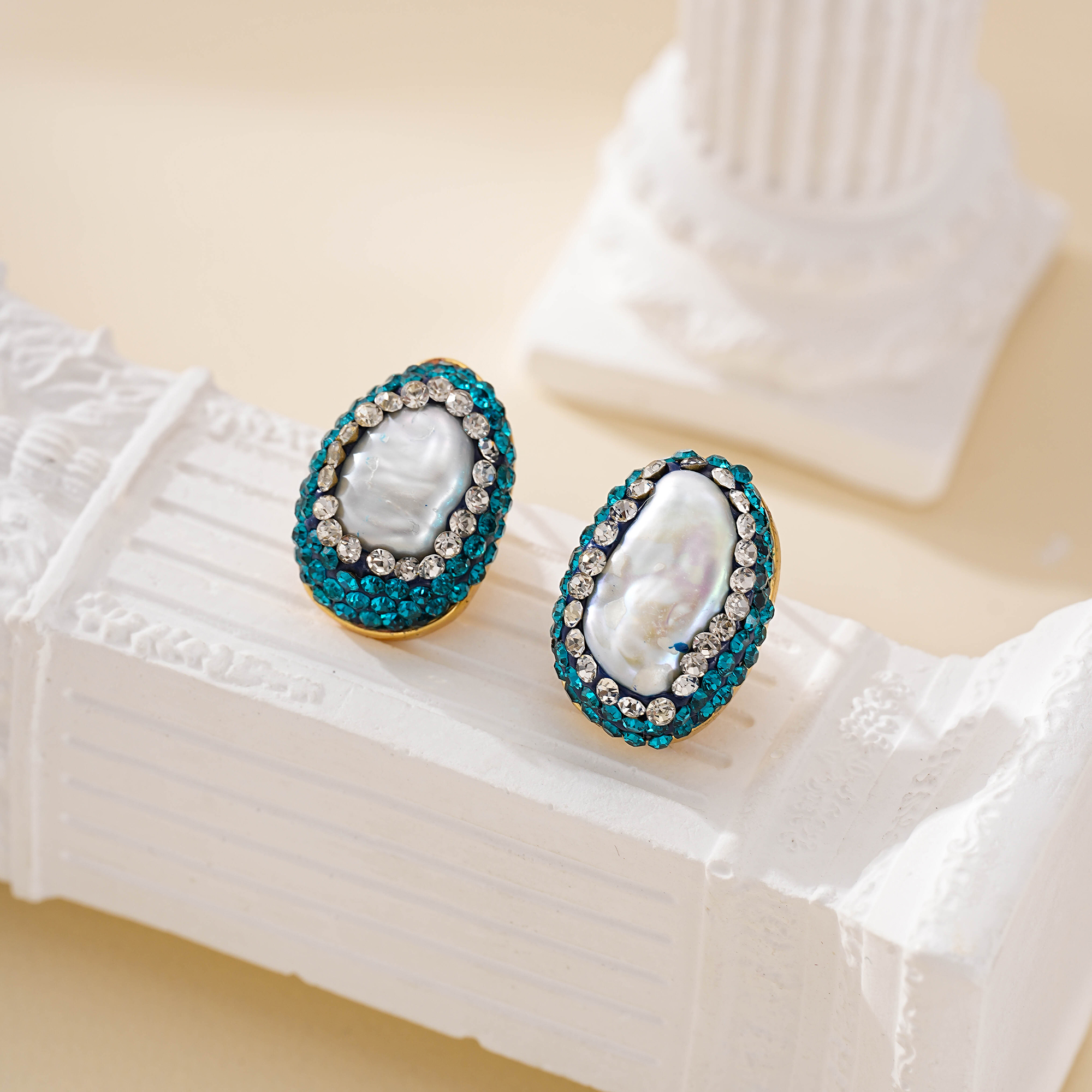Close view of green and white accents around a baroque pearl