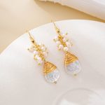 Close view of wire-wrapped tips on large teardrop pearls