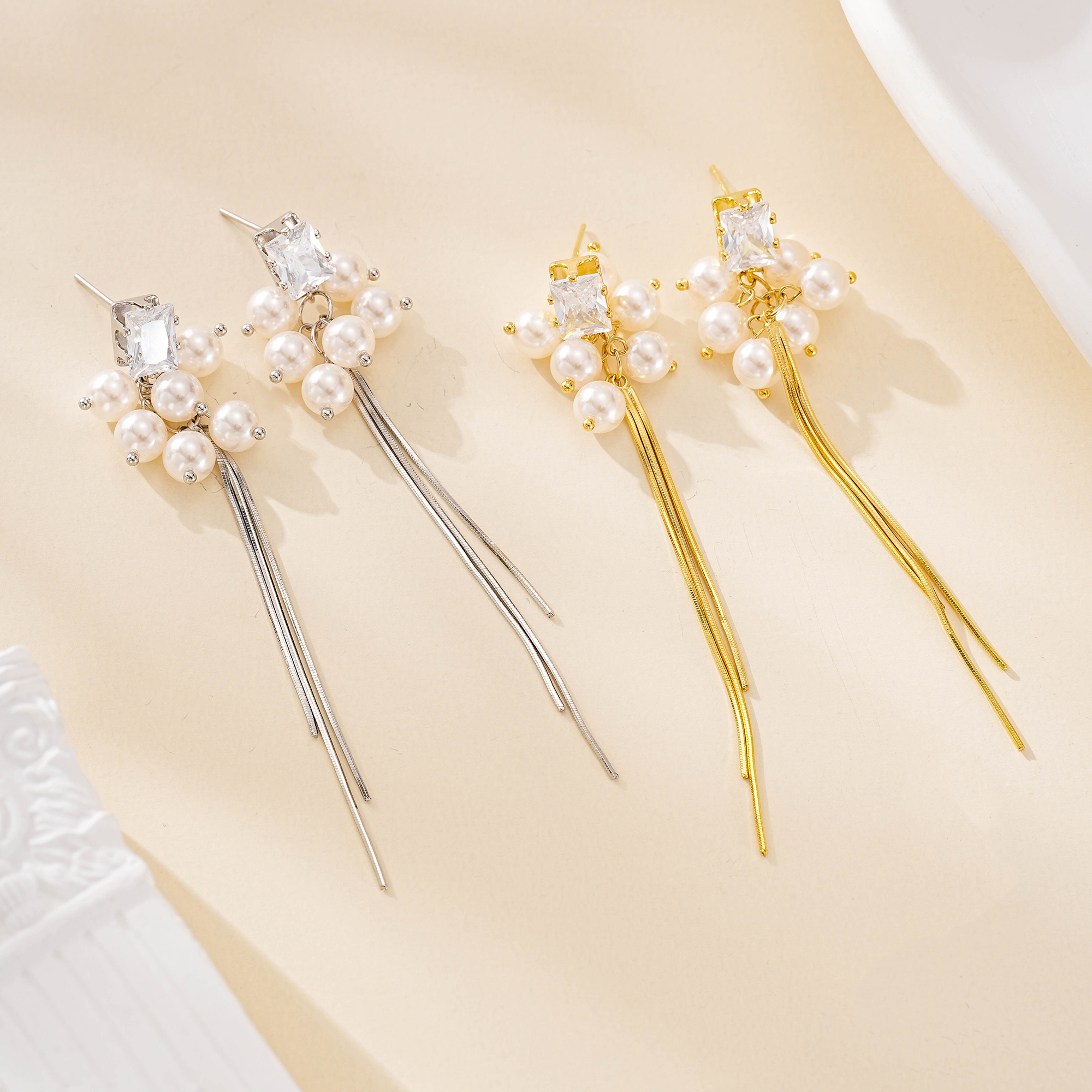 Pearl cluster tassel earrings shown in gold and silver finishes