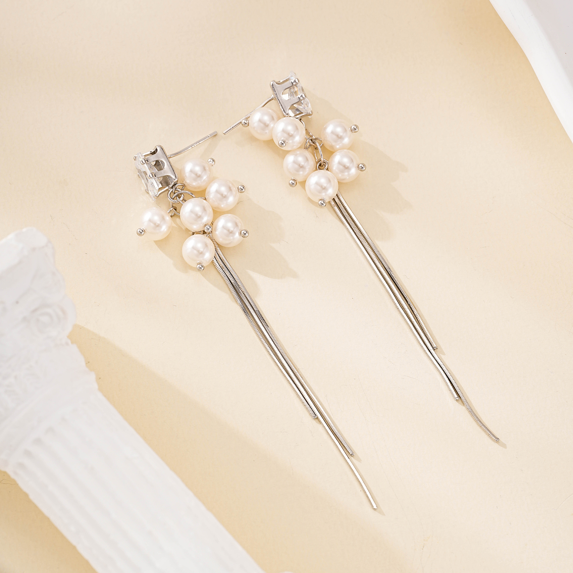 Silver-tone pearl drop earrings with three slender tassels