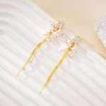 Gold-tone tassels below clear rectangular studs and pearls