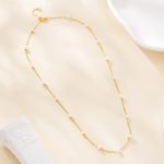 Full view of the spaced-pearl layering necklace
