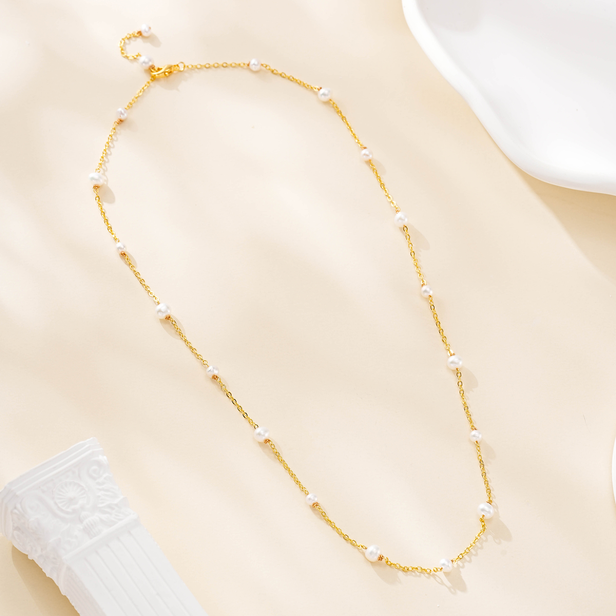 Full view of the spaced-pearl layering necklace
