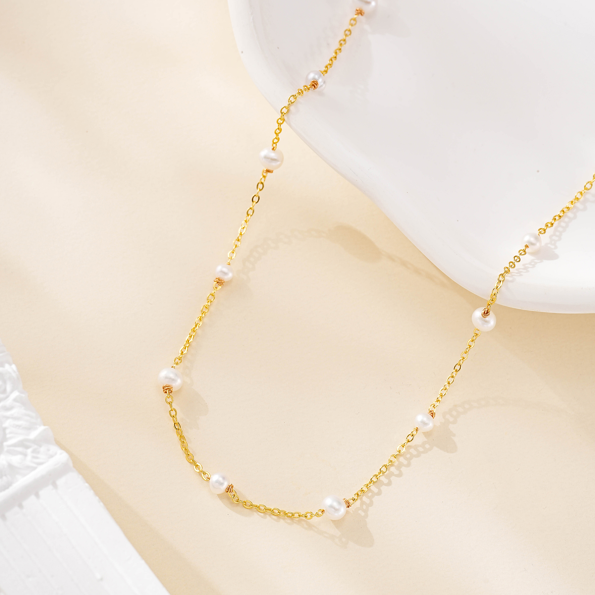 Long gold-tone necklace with spaced freshwater pearls