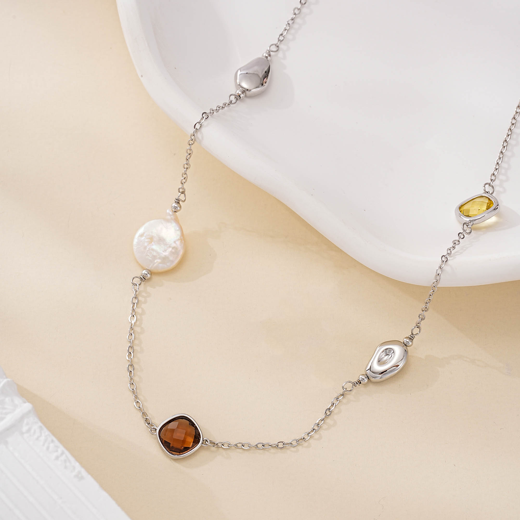 Long silver-tone station necklace with pearls and resin accents