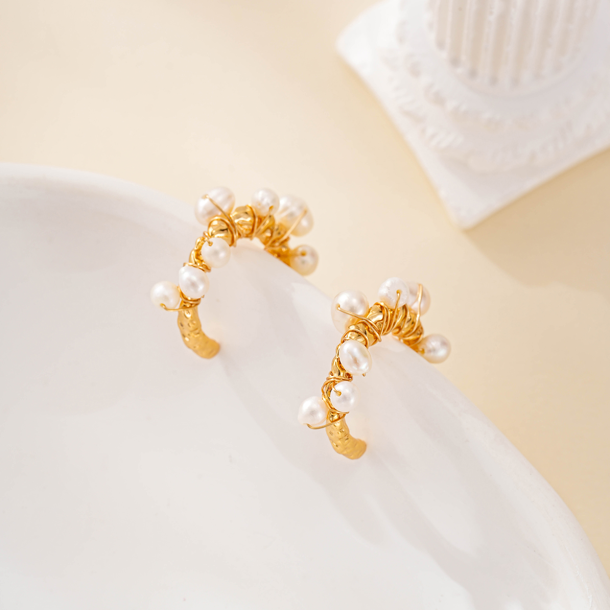 Side view of wire-wrapped pearl hoop earrings